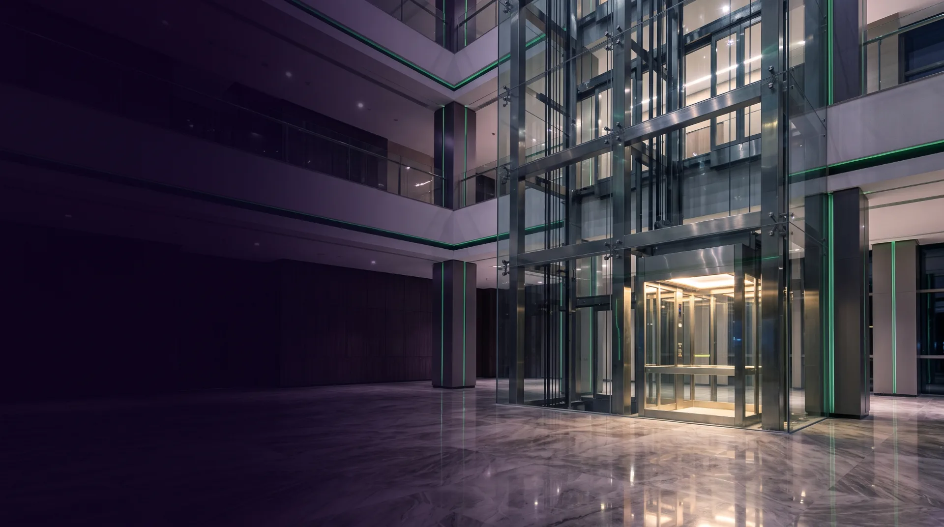 Modern glass passenger elevator in a bright high-rise building lobby
